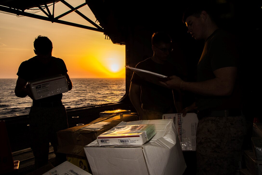 U.S. Marines assigned to 26th Marine Expeditionary Unit (MEU), sort mail in the hanger bay of the USS Kearsarge (LHD 3) after a resupply at sea, July 20, 2013. The ship received 136 pallets of mail, the largest shipment on this deployment. The 26th MEU is a Marine Air-Ground Task Force forward-deployed to the U.S. 5th Fleet area of responsibility aboard the Kearsarge Amphibious Ready Group serving as a sea-based, expeditionary crisis response force capable of conducting amphibious operations across the full range of military operations. (U.S. Marine Corps photo by Sgt. Christopher Q. Stone, 26th MEU Combat Camera/Released)