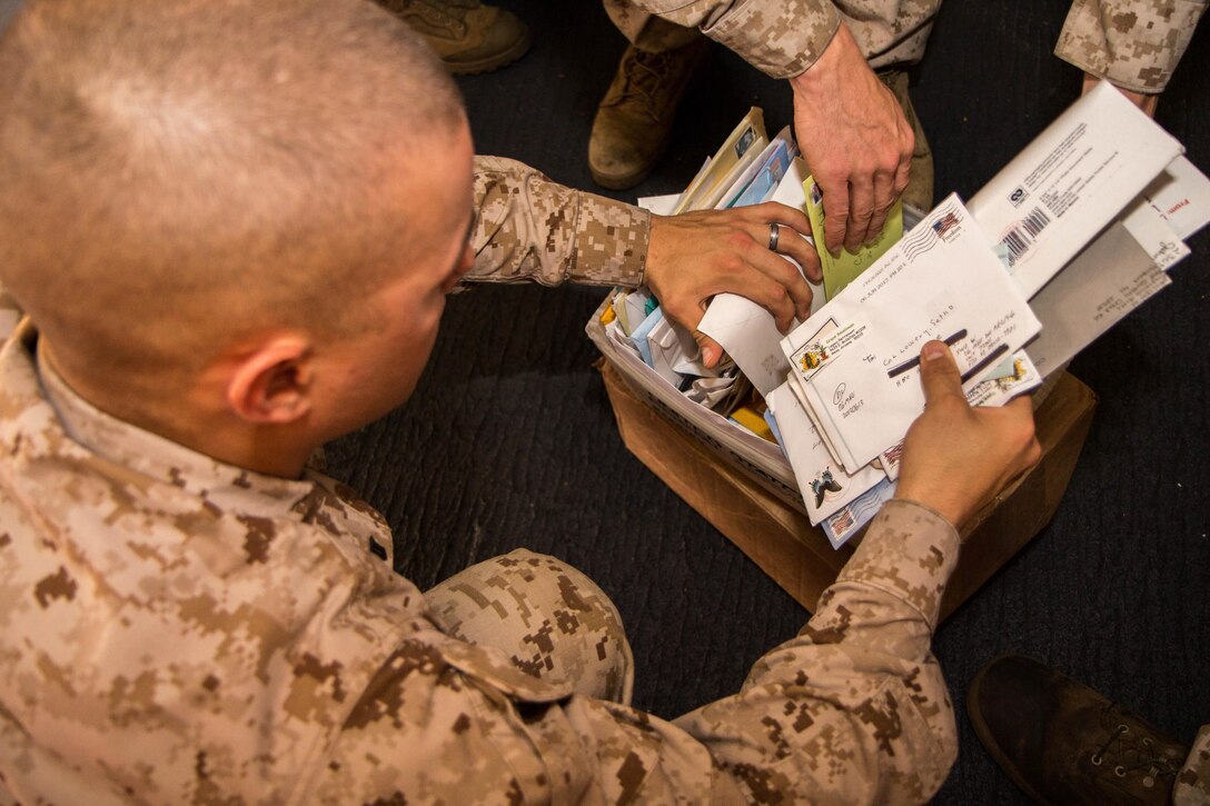 U.S. Marines assigned to 26th Marine Expeditionary Unit (MEU), sort mail in the hanger bay of the USS Kearsarge (LHD 3) after a resupply at sea, July 20, 2013. The ship received 136 pallets of mail, the largest shipment on this deployment. The 26th MEU is a Marine Air-Ground Task Force forward-deployed to the U.S. 5th Fleet area of responsibility aboard the Kearsarge Amphibious Ready Group serving as a sea-based, expeditionary crisis response force capable of conducting amphibious operations across the full range of military operations. (U.S. Marine Corps photo by Sgt. Christopher Q. Stone, 26th MEU Combat Camera/Released)