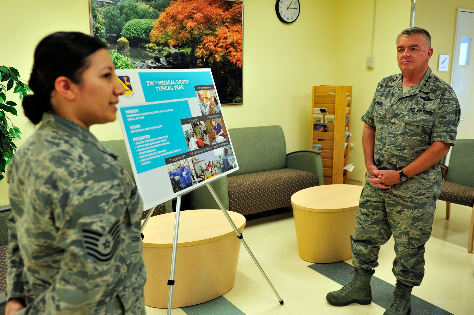 YOKOTA AIR BASE, Japan -- Lt. Gen. (Dr.) Thomas Travis, Air Force Surgeon General, receives a briefing from Tech. Sgt. Elizabeth Jakubowski, 374th Medical Support Squadron, July 19, 2013, at Yokota Air Base, Japan. The briefing included overall information about the 374th Medical Group and its typical workload throughout a year. (U.S. Air Force photo by Senior Airman Cody H. Ramirez)