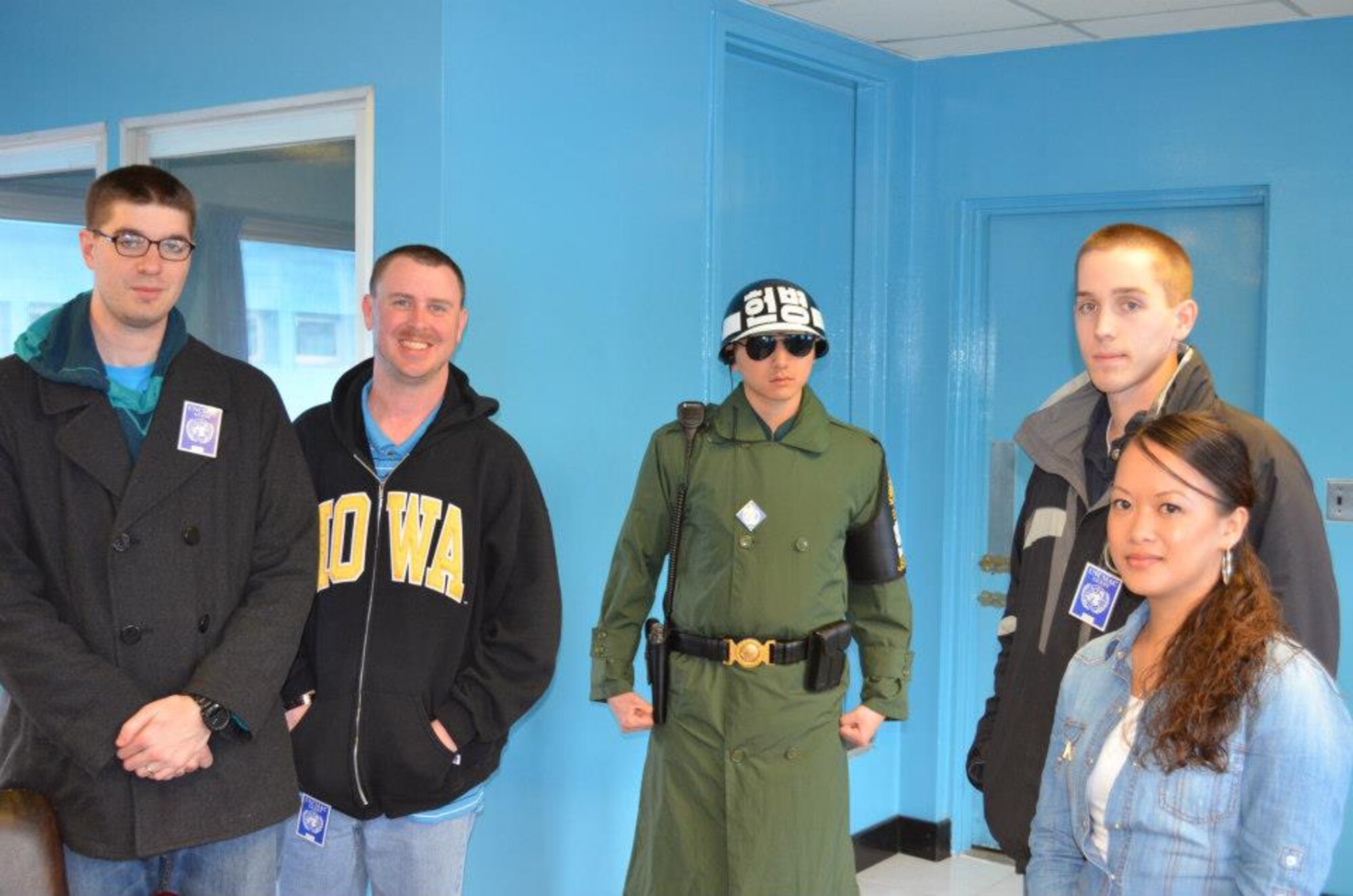 Members of the 8th Operations Support Squadron pose with a Republic of Korea Soldier on the Democratic People’s Republic of Korea side of the Conference Row Building at the Demilitarized Zone, April 19, 2013. The building is used by both North and South Korea to hold meetings in the Joint Security Area, where the Armistice Agreement of July 27, 1953 was signed. (Courtesy photo)