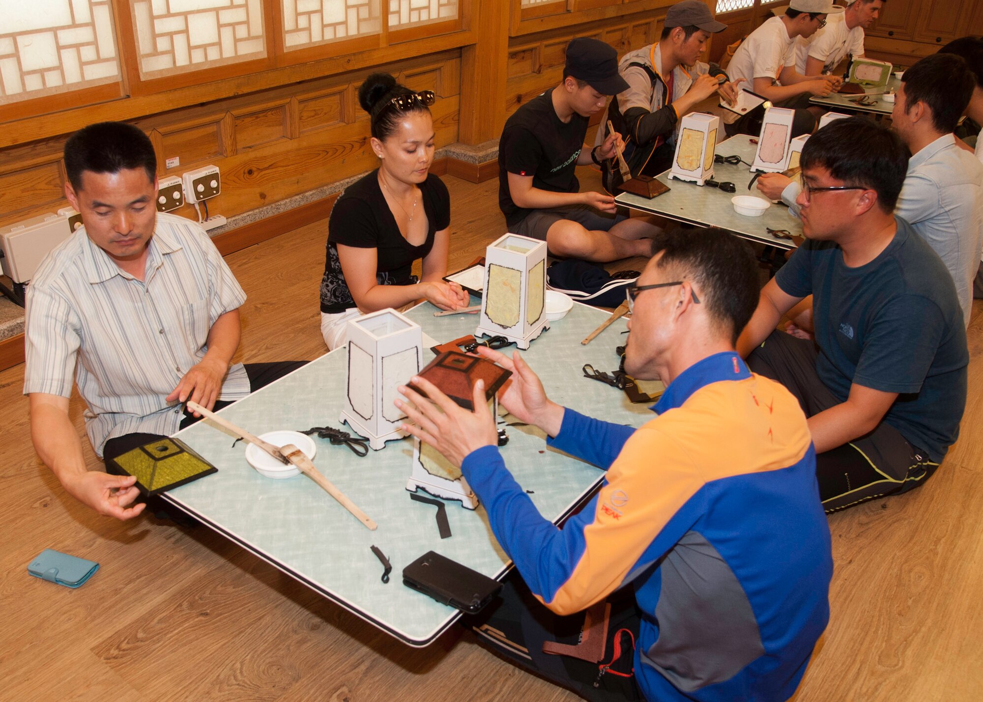 Eighth Fighter Wing and Republic of Korea, 38th Fighter Group airmen participate in a lantern-making class during their trip to Jeonju Han-ok Village, ROK, June 11, 2013. This participatory class took place at the Jeonju Culture Center, where other classes such as masked dancing are also taught. (U.S. Air Force photo by Senior Airman Jessica Haas/ Released)