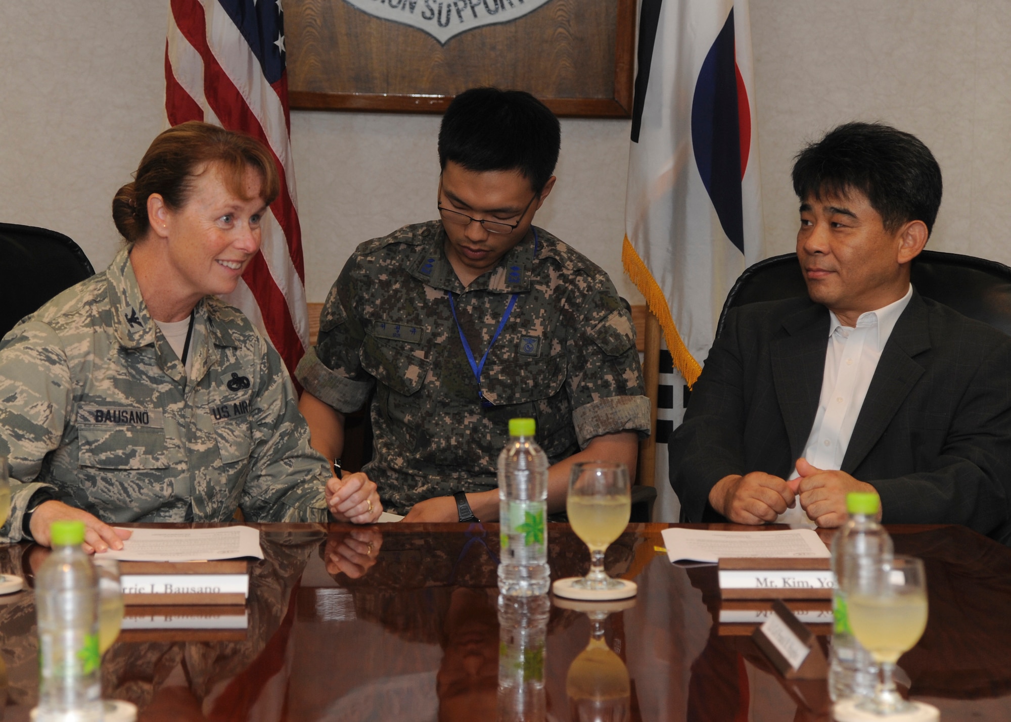 Colonel Carrie Bausano, 8th Mission Support Group commander, welcomes Mr. Kim Young Il, Republic of Korea air force Operation Center representative, during their meeting to sign an agreed recommendation to allow joint use of real estate on Kunsan Air Base, ROK, July 11, 2013. This agreement will allow construction of ROKAF anti-aircraft missile platforms at important locations formerly exclusive to the United States Forces Korea. (U.S. Air Force photo by Senior Airman Jessica Haas/released)