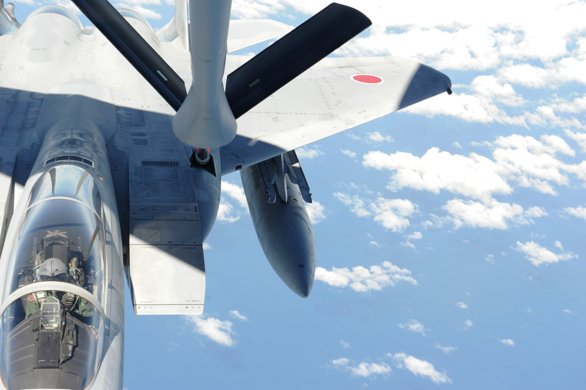 A Japan Air Self Defense Force F-15J jet connects to a KC-135 Stratotanker boom during a bilateral refueling mission over the Pacific Ocean, July 11, 2013. The 909th Air Refueling Squadron conducted a bilateral refueling mission with JASDF F-15J jets to help prepare them for an upcoming training exercise, Red Flag Alaska. The mission also gave both services the opportunity to work together in an operational environment which allowed them to adapt to the subtle differences in terminology and language. (U.S. Air Force photo by Airman 1st Class Malia Jenkins/Released)   