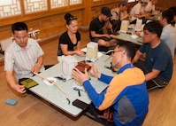 Eighth Fighter Wing and Republic of Korea, 38th Fighter Group airmen participate in a lantern-making class during their trip to Jeonju Han-ok Village, ROK, June 11, 2013. This participatory class took place at the Jeonju Culture Center, where other classes such as masked dancing are also taught. (U.S. Air Force photo by Senior Airman Jessica Haas/ Released)