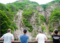 Eighth Fighter Wing and Republic of Korea 38th Fighter Group airmen stop to admire the view during their hike at Mount Gangchun Park, ROK, June 10, 2013. This large waterfall was just one of many sights Airmen had the opportunity to take in while on their two-day ROK air force-sponsored trip. (U.S. Air Force photo by Senior Airman Jessica Haas/Released)   