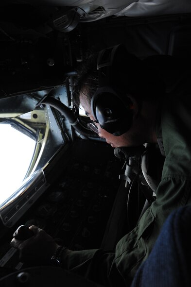 Lt. Gen. Yoshiyuki Sugiyama, Japan Air Self Defense Force Southwestern Composite Air Division commander, operates the boom of a KC-135 Stratotanker during a joint refueling mission with JASDF F-15J jets and 909th Air Refueling Squadron over the Pacific Ocean, July 11, 2013. The bilateral refueling mission between the 909th ARS and JASDF pilots gave both services the opportunity to work together in an operational environment in preparation for an upcoming training exercise, Red Flag Alaska. (U.S. Air Force photo by Airman 1st Class Malia Jenkins/Released)     
