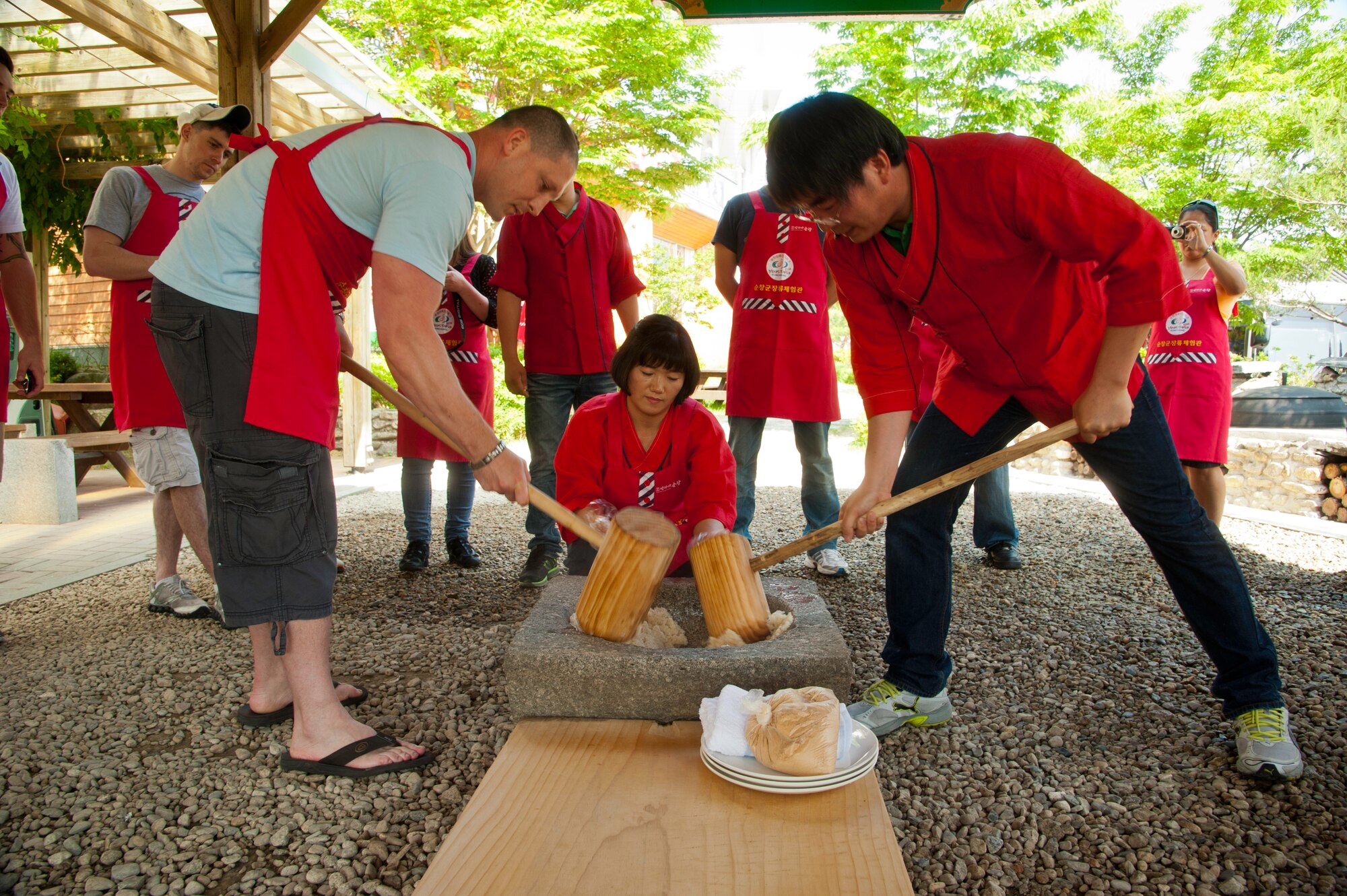 Eighth Fighter Wing and Republic of Korea 38th Fighter Group airmen learn to make rice cakes during a trip to Sunchang Gochujang Village, ROK, June 10, 2013. The two day tour of South Korea allowed U.S. and ROK airmen assigned to Kunsan Air Base, ROK to strengthen cross-cultural communications. (U.S. Air Force photo by Senior Airman Jessica Haas/ Released)  