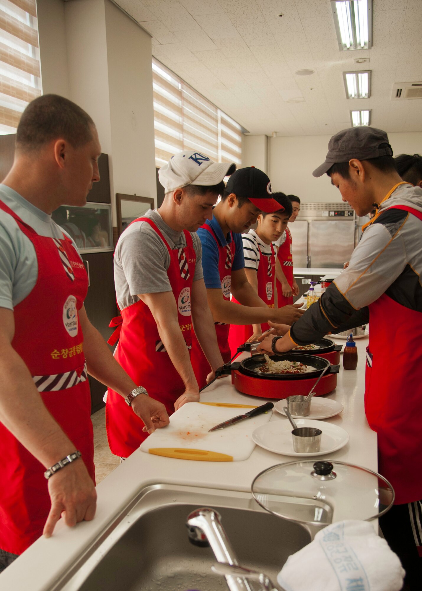 Eighth Fighter Wing and Republic of Korea 38th Fighter Group airmen learn to make Korean-style pizza during a trip to Sunchang Gochujang Village, ROK, June 10, 2013. The airmen learned to make pizza, rice cake, rice pop and red chili pepper paste. (U.S. Air Force photo by Senior Airman Jessica Haas/ Released)
