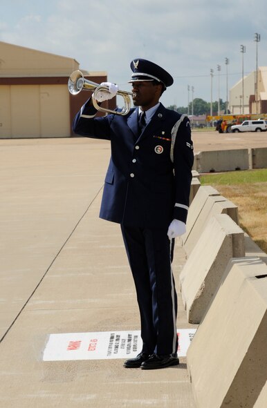 Airman 1st Class Adrian Green, Barksdale Honor Guard, plays "Taps" during a remembrance ceremony dedicated to crewmembers of RAIDR 21 on Barksdale Air Force Base, La., July 21, 2013. The Barksdale Honor Guard performs honors at military ceremonies and funerals. (U.S. Air Force photo/Airman 1st Class Andrew Moua)