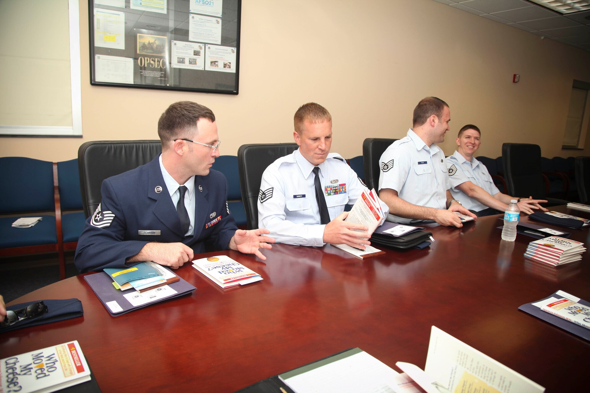 Technical Sgt. Brian Pearson and Staff Sgt. Jeremy Nunnery, both air transportation specialists with the 38th Aerial Port Squadron here at Joint Base Charleston, S.C., discuss the book "Who Moved My Cheese?" today before a training class during the junior NCO training event here. (U.S. Air Force photo by Staff Sgt. Rashard Coaxum/released)