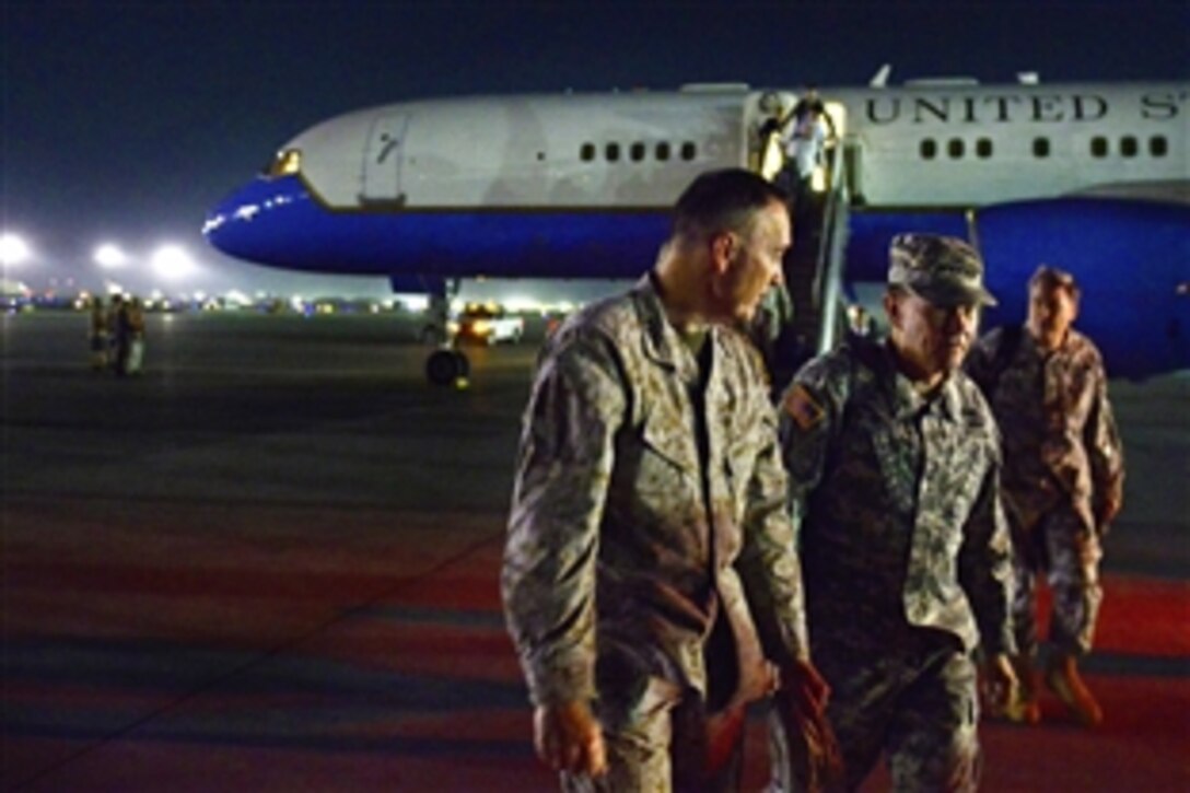 U.S. Army Gen. Martin E. Dempsey, chairman of the Joint Chiefs of Staff, talks with U.S. Marine Corps Gen. Joseph F. Dunford Jr., commander of the International Security Assistance Force, on arrival on Bagram Airfield, Afghanistan, July 20, 2013.  