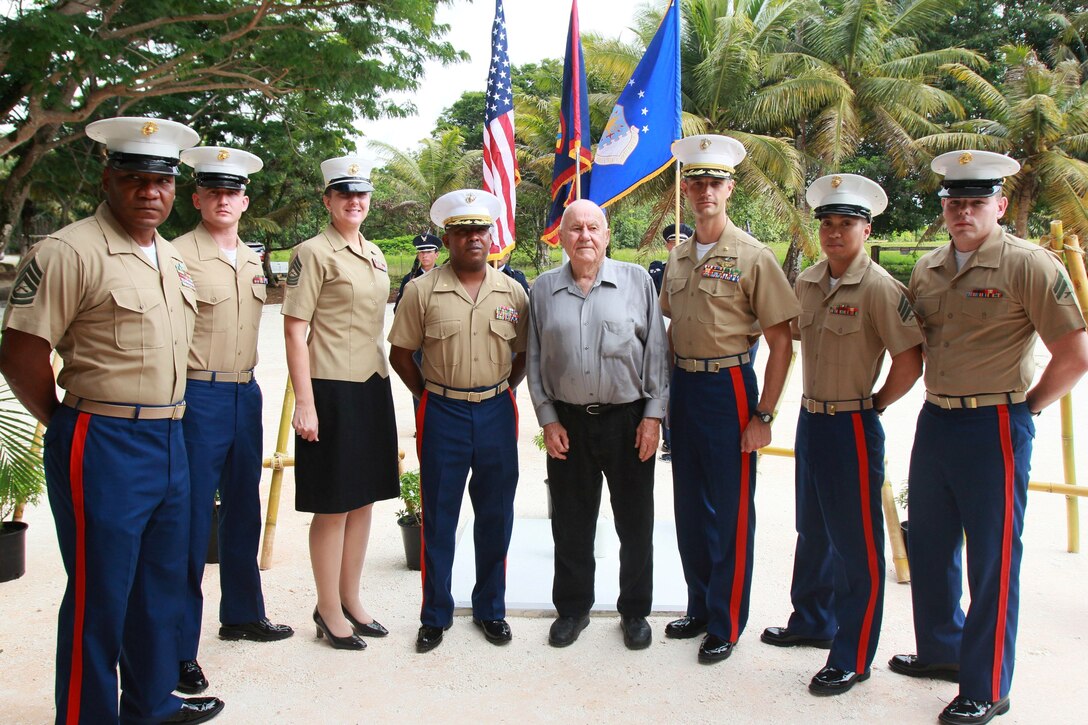 Marines with Marine Corps Activity Guam pose with William Mays, a Marine who fought on Guam in 1944 during the liberation, at the Chagui’an Massacre memorial event July 16 in Yigo, Guam.  On this site, Japanese fighters massacred a group of Chamorro men after forcing them to move supplies across the island.  The ceremony was one of many held across the island to celebrate the liberation of the island from Japanese oppression and occupation in 1944.  The Guam Marines wrapped up support for the island’s 69th Liberation celebration Sunday by participating in the Liberation Day Parade, the culminating event in a series of ceremonies and celebrations across the island held to honor those lost and celebrate the liberation of the island.  (Official U.S. Marine Corps photo by Sgt. John Raufmann)   
