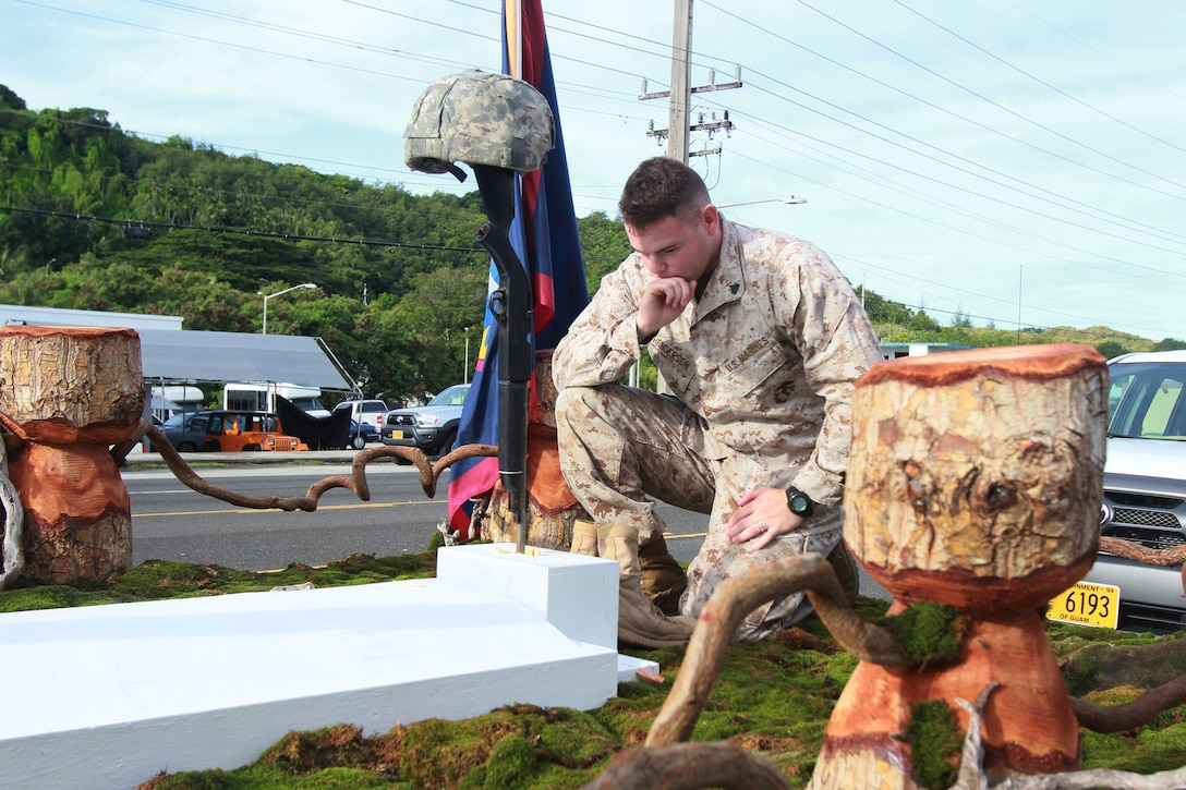 Corporal Chris Henderson, a native of Arkansas and the training chief for Marine Corps Activity Guam, kneels as part of the presentation of the Department of Public Works float during the Liberation Day Parade July 21 at Adelup, Guam.  Marine Corps Activity Guam Marines wrapped up support for the island’s 69th Liberation celebration Sunday by participating in the Liberation Day Parade, the culminating event in a series of ceremonies and celebrations across the island held to honor those lost and celebrate the liberation of the island during World War II.  Local villages and organizations hosted the Guam Marines on various floats in the parade in appreciation for the Marines who liberated the island from Japanese occupation in 1944.  (Official U.S. Marine Corps photo by Sgt. John Raufmann)  