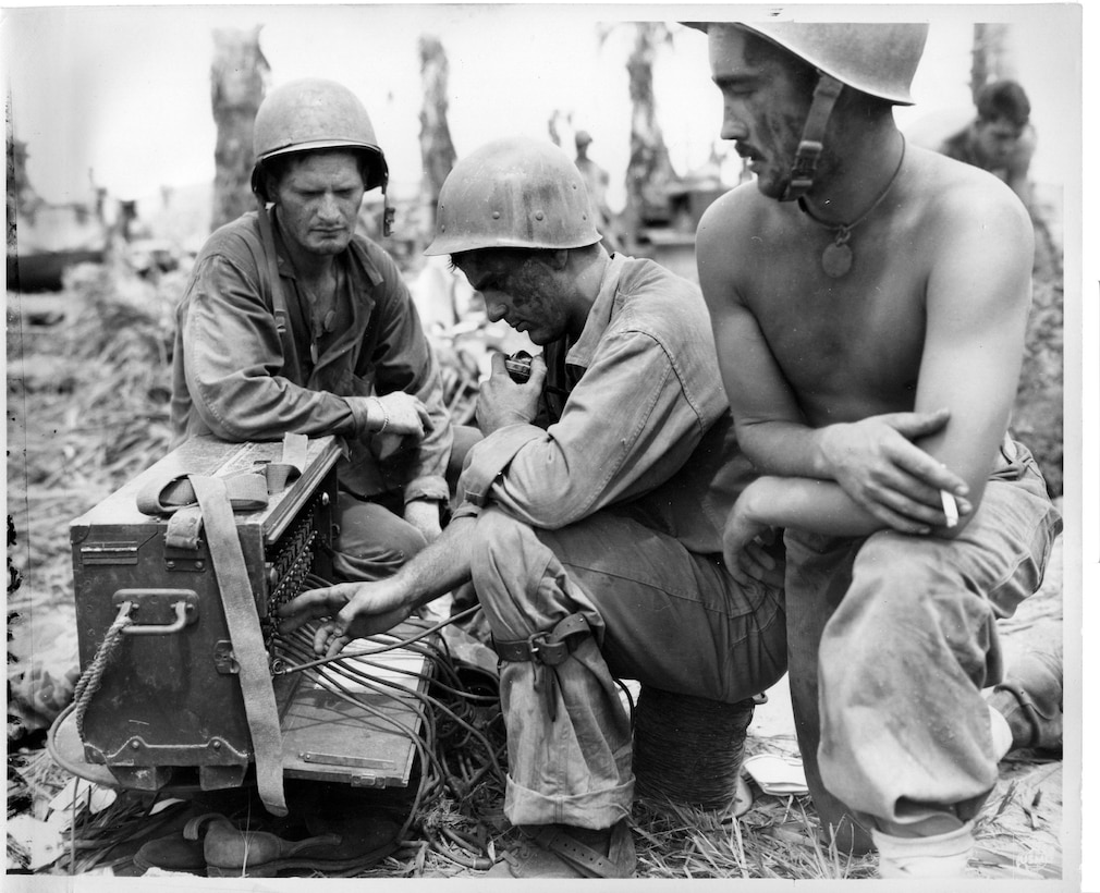 Marines set up communication systems after securing a beachhead to talk with other units during the liberation of Guam July 21, 1944.  Marine Corps Activity Guam Marines supported events during this year’s 69th Liberation celebration to honor those lost and celebrate the liberation of the island.  The annual celebration is a series of memorials and fiestas to honor both Chamorros and Marines lost in the 1941 Japanese invasion and occupation, as well as the 1944 liberation of the island.  (Official U.S. Marine Corps photo by Sgt. John Raufmann)  