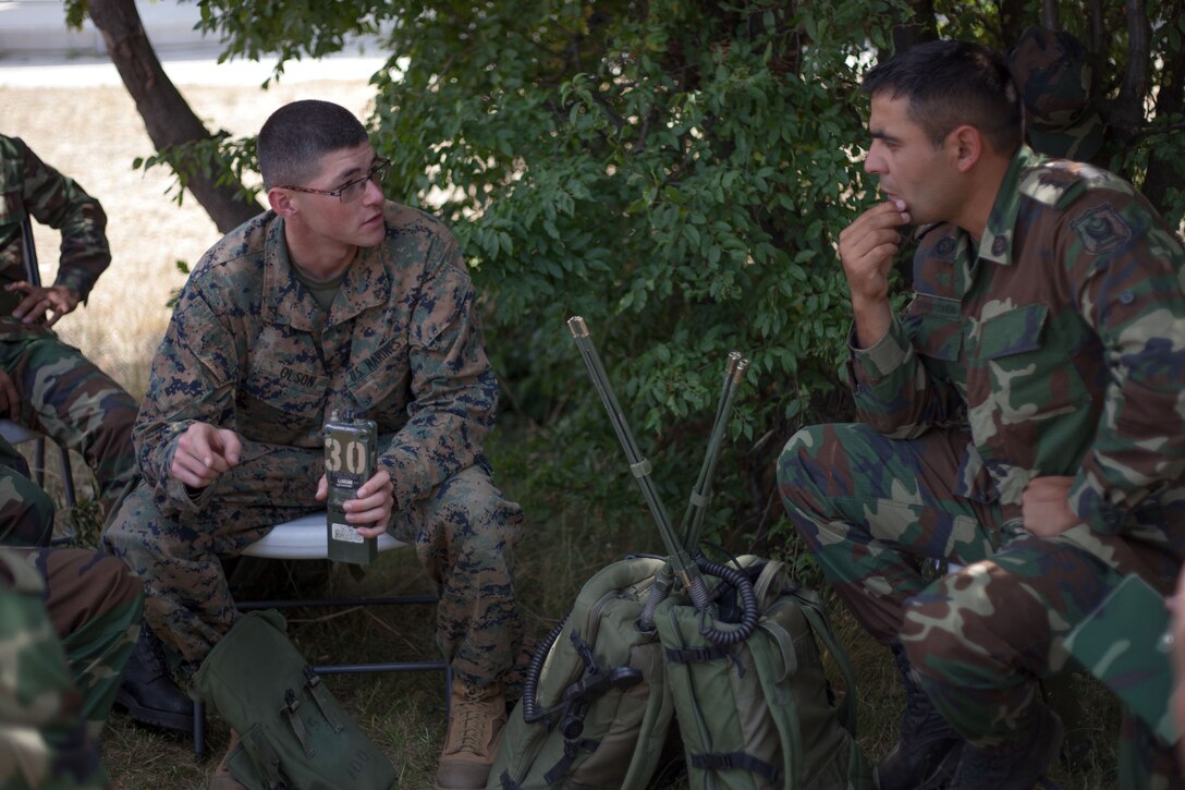 U.S. Marine Corps Lance Cpl. Jacob Olson, a radio operator with Black Sea Rotational Force 13, discusses handheld radio capabilities and limitations alongside soldiers with Azerbaijan’s Operational Capabilities Concept battalion during a communications platoon information exchange part of Exercise Platinum Lion 13 at Novo Selo Training Area, Bulgaria, July 20, 2013. BSRF-13 focuses on stability, counter-insurgency, and peacekeeping operations, in order to build partner-nation capacity, enhance interoperability between countries and increase overall effectiveness of participating military forces. 