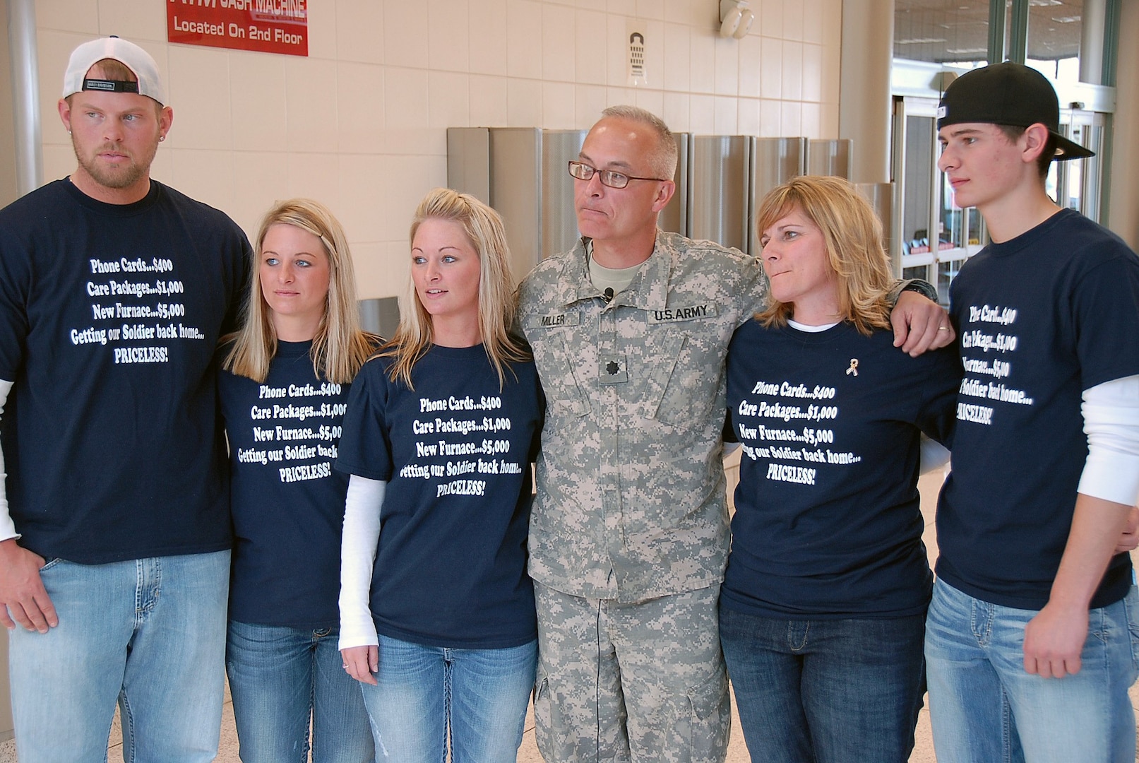 The Miller family gets ready for an interview with a local television station. The family is big on making T-shirts to celebrate occasions and had this particular shirt in mind for quite some time. Lt. Col. Russell Miller returned from a deployment to Afghanistan with the Wisconsin Army National Guard's fourth Embedded Training Team March 26, 2010.