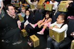 Trevor Romain, award-winning author and children's books illustrator, jokes with military children after a USO-sponsored film screening of the DVD "With You All the Way" at the U.S. Navy Memorial in Washington, D.C., March 30, 2010. The DVD was designed for military children dealing with deployment.