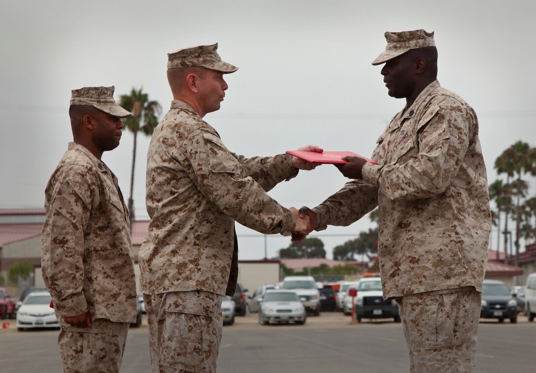 Master Sgt. Marson A. Giffith, communications chief, Command Element, 15th Marine Expeditionary Unit, receives a Meritorious Service Medal from  Lt. Col. John R. O'Neal, commanding officer, 15th Marine Expeditionary Unit, during an awards ceremony held at the Camp Del Mar Parade Deck aboard Camp Pendleton, Calif., July 18. Griffith received the award for the superior performance of his duties as the unit's communications chief. Griffith is from Wallkill, N.Y. (U.S. Marine Corps photo by Cpl. Emmanuel Ramos/Released)