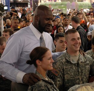 Army National Guardsmen Maygen Matson (left) and Taylor Anonson pose for photos with NBA superstar Shaquille O'Neal.