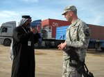 Al-Ghezy Trucking and General Contracting Company owner Jameel Jabir discusses hauling schedules with 287th Sustainment Brigade IBIZ (Iraqi-Based Industrial Zone) Manager 1st Lt. Andrew Wright, 287th Sustainment Brigade. Jabir maintains a satellite office at the IBIZ complex and leases a large yard there to park a portion of his 300-plus trucks when they are idle.