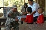 Spc. Andrew Kalaukoa of Makaha, Hawaii, distributes milk to the children of the Ban Pong Wua School in rural Thailand as part of the Cobra Gold joint humanitarian mission hosted at the Ban Nong Buatong School in the Chanthaburi District of Thailand Jan. 24 to Feb. 11. Present on the new classroom facility job site were the Hawaii National Guard, 230th Engineer Company, Vertical and the Royal Thai Marine Engineer Battalion.