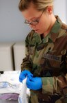 Senior Airman Amber Wonderly of the 180th Fighter Wing prepares equipment for use in an operation on a patient simulator Jan. 11 in the Center for Medical Education + I at Riverside Methodist Hospital.