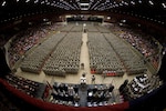 32nd Brigade Command Sgt. Maj. Ed Hansen, on floor in front of podium, accepts reports from battalion command sergeants major as the brigade forms at the start of the Feb. 17 send-off ceremony at the Dane County Veterans Memorial Coliseum, Madison, Wis. Family members and public officials bade farewell to some 3,200 members of the 32nd Infantry Brigade Combat Team and augmenting units, Wisconsin Army National Guard, in the ceremony. The unit is bound for pre-deployment training at Fort Bliss, Texas, followed by a deployment of approximately 10 months for Operation Iraqi Freedom.