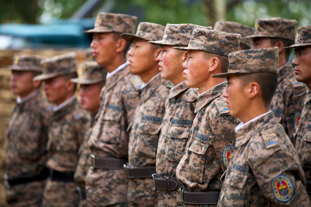 Mongolian Armed Forces engineers with 017 Construction Regiment receive instructions from their supervisor prior to starting work, July 22. A multinational team of engineers, which includes U.S. Marines with 9th Engineer Support Battalion and U.S. Army soldiers with 96th Troop Command, are working together to renovate Erdmiin Oyun High School in the Nalaikh district of Ulaanbaatar as part of Exercise Khaan Quest 2013. Khaan Quest is a regularly scheduled, multinational exercise co-sponsored this year by U.S. Marine Corps Forces Pacific, and hosted annually by the MAF. The intent of the ongoing engineering civic action program (ENCAP) project in Nalaikh is to provide valuable training for Mongolian and U.S. armed forces by boosting their interoperability, as well as demonstrate a mutual commitment to local community.