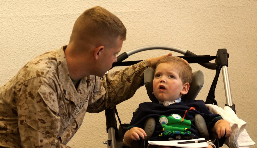 Sgt. Andrew Fischer, a crew chief with 2nd Marine Division’s 2nd Tank Battalion, comforts his son during a forum about traumatic brain injuries and neurological disorders hosted by the Exceptional Family Member Program at the Russell Marine and Family Center aboard Marine Corps Base Camp Lejeune, July 10.Fischer said he hopes to see more families attend such events.