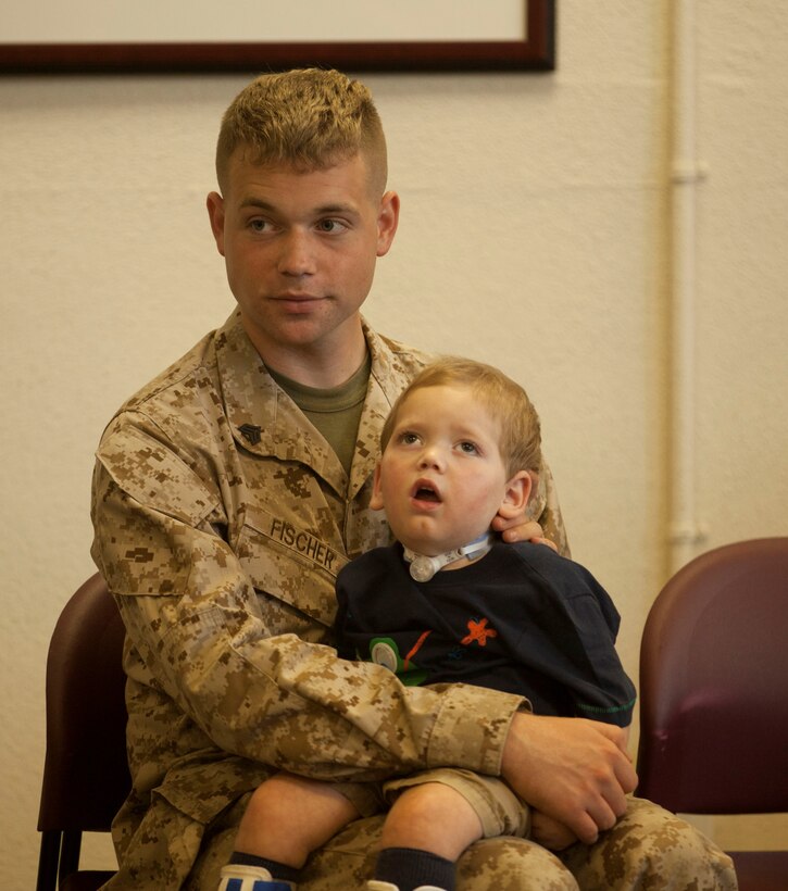 Sgt. Andrew Fischer, a crew chief with 2nd Marine Division’s 2nd Tank Battalion, comforts his son during a forum about traumatic brain injuries and neurological disorders hosted by the Exceptional Family Member Program at the Russell Marine and Family Center aboard Marine Corps Base Camp Lejeune, July 10.Fischer said he hopes to see more families attend such events.