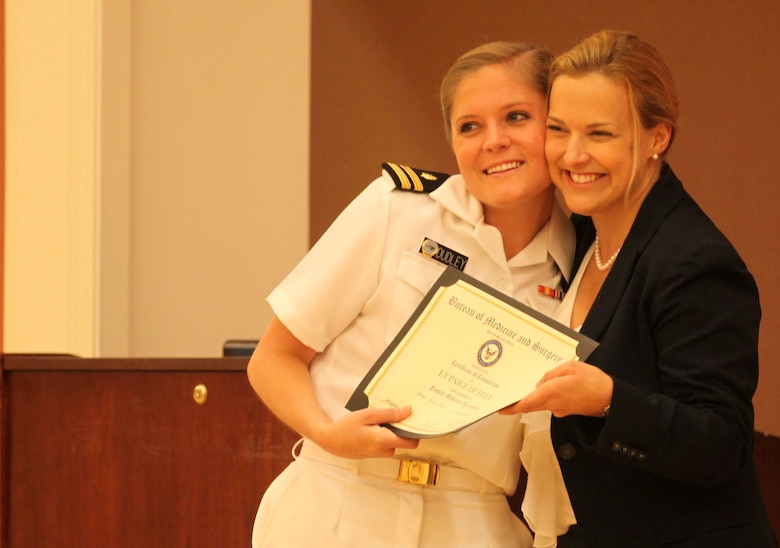 Lt. Paige Dudley, a graduating intern, hugs Phyllis MacGilvray after receiving a certificate from Phyllis MacGilvray, the program director of Naval Hospital Camp Lejeune's Family Residency Program at the program’s graduation ceremony at Marston Pavilion aboard Marine Corps Base Camp Lejeune, June 28.  This year’s class is the tenth to graduate. To date, 51 family physicians have been trained at the hospital. 