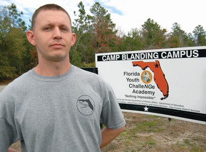 Former Florida Youth ChalleNGe Academy cadet Jonathan Aman stands outside the Academy campus at Camp Blanding Joint Training Center, nearly nine years after he graduated from the Youth ChalleNGe program. Now Aman, 26, has returned as a member of the Youth ChalleNGe cadre, and is sharing his experiences with the newest cadets.