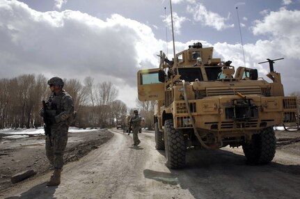 A security forces member of the provincial reconstruction team in Afghanistan's Paktia province scans the area after the convoy stopped during a mission to drop humanitarian aid, Feb. 24, 2009, in the province's Sayed Karem district.