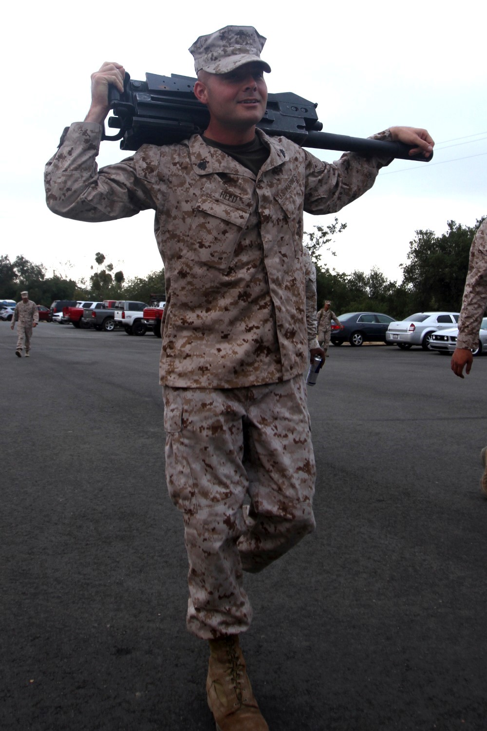 Sergeant Thomas Reed, a training noncommissioned officer serving with Truck Company Alpha, Headquarters Battalion, 1st Marine Division, carries a Mk-19 grenade launcher to a classroom during the Basic Mk-19 Heavy Machine Gun Course here, June 11, 2013. Throughout the course, support Marines were instructed by experienced machine gunners who are combat veterans. The course tested Marines on the weapon nomenclature, weapon conditions, the weapon's range, different types of ammunition and range cards. Reed, a native of Wooster, Ohio, was sent to the course to prepare himself and his junior Marines for an upcoming combat deployment to Afghanistan.