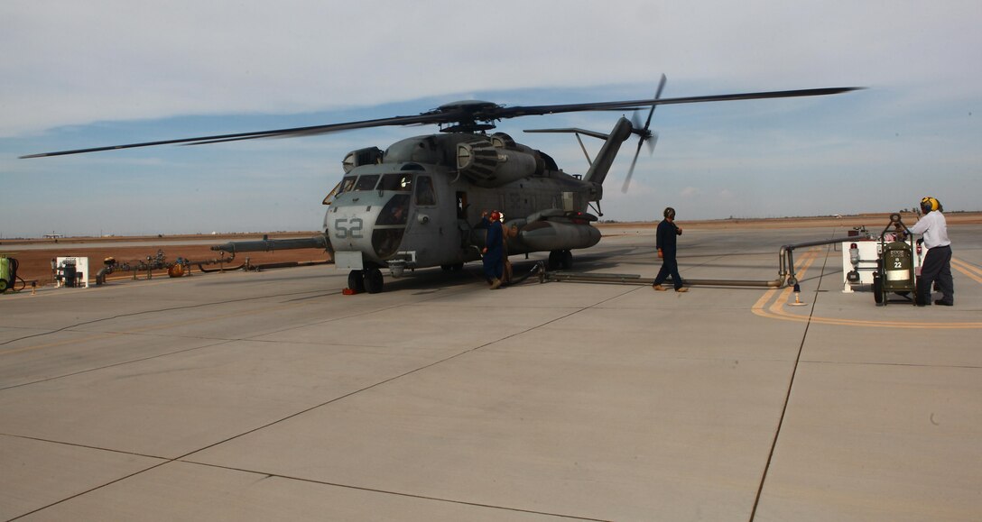 A CH-53E Super Stallion refuels for the trip back to Marine Corps Air Station Miramar, Calif., at Imperial County Airport in El Centro, Calif., July 17.During refueling Staff Sgt. Franklin Williams, an aviation ordnance technician with Marine Heavy Helicopter Squadron 465 "Warhorses" and a San Diego native, kept watch from outside the aircraft to ensure those who were not qualified to touch the aircraft maintained a safe distance, much like he would when he earns his aerial observer's wings.