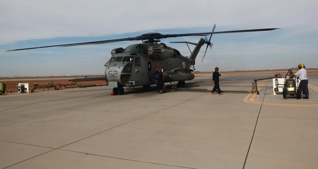 A CH-53E Super Stallion refuels for the trip back to Marine Corps Air Station Miramar, Calif., at Imperial County Airport in El Centro, Calif., July 17.During refueling Staff Sgt. Franklin Williams, an aviation ordnance technician with Marine Heavy Helicopter Squadron 465 "Warhorses" and a San Diego native, kept watch from outside the aircraft to ensure those who were not qualified to touch the aircraft maintained a safe distance, much like he would when he earns his aerial observer's wings.