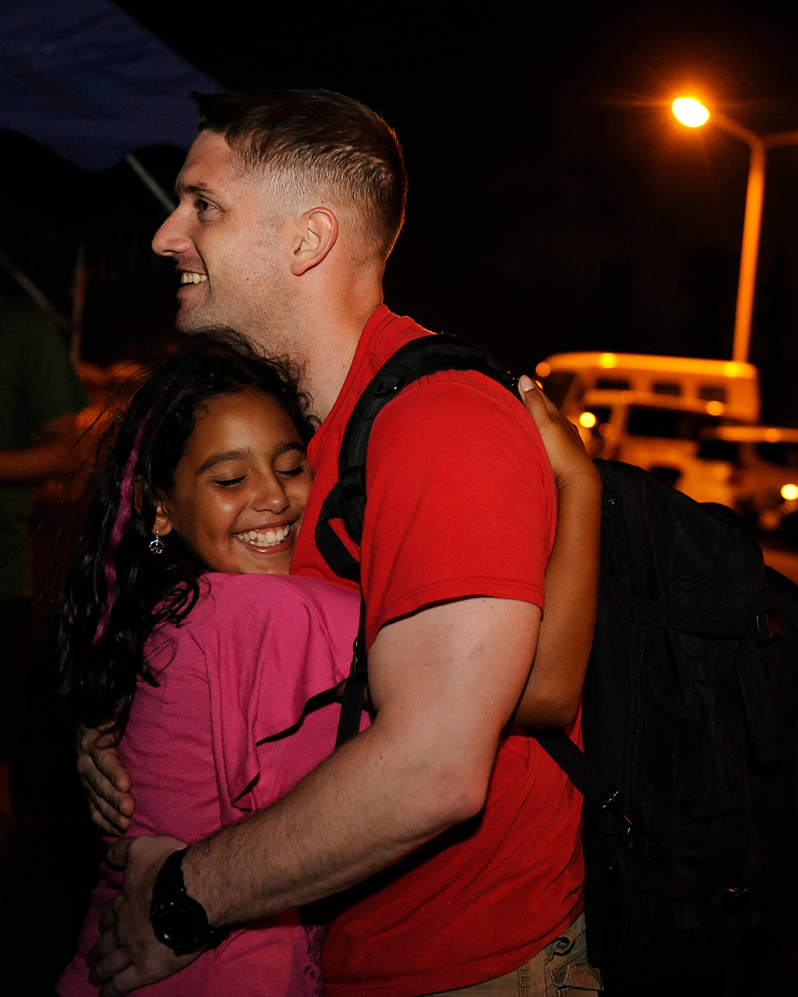U.S. Air Force 1st Lt. Keith Rybicki, 961st Airborne Air Control Squadron air weapons officer, greets his daughter, Alondra, on Kadena Air Base, Japan, July 19, 2013, after returning from a deployment to Southwest Asia. While deployed, the 24 deployed service members from the 961st AACS, including Rybicki, flew 24 combat missions totaling 293 flight hours, during which time they controlled 253 aircraft in 136 restricted operating zones in support of Operation Enduring Freedom and the joint defense of the Arabian Gulf. (U.S. Air Force photo by Senior Airman Maeson L. Elleman/Released)