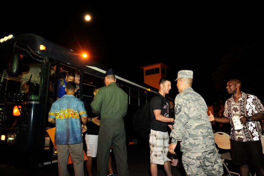 Members from the 961st Airborne Air Control Squadron greet returning service members during a redeployment on Kadena Air Base, Japan, July 19, 2013. While deployed, the service members flew 24 combat missions totaling 293 flight hours, during which time they controlled 253 aircraft in 136 restricted operating zones in support of Operation Enduring Freedom and the joint defense of the Arabian Gulf. (U.S. Air Force photo by Senior Airman Maeson L. Elleman/Released)