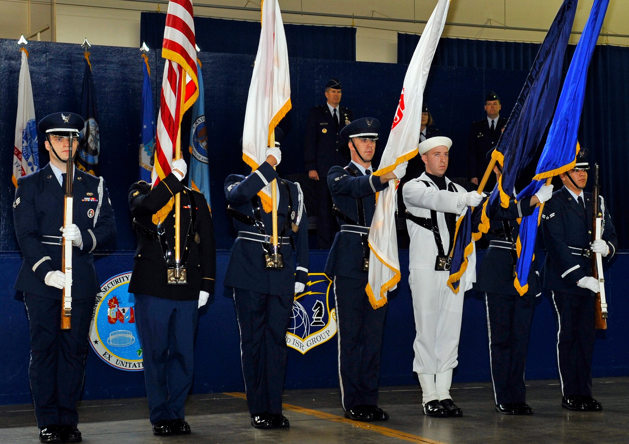 Members of the Misawa Honor Guard present the colors during a change of command ceremony at Misawa Air Base, Japan, June 26, 2013. Honor Guard is a volunteer-based program where members work sections sign a contract giving them time to complete Honor Guard ceremonies around base during their work time. (U.S. Air Force photo by Airman 1st Class Zachary Kee)  
