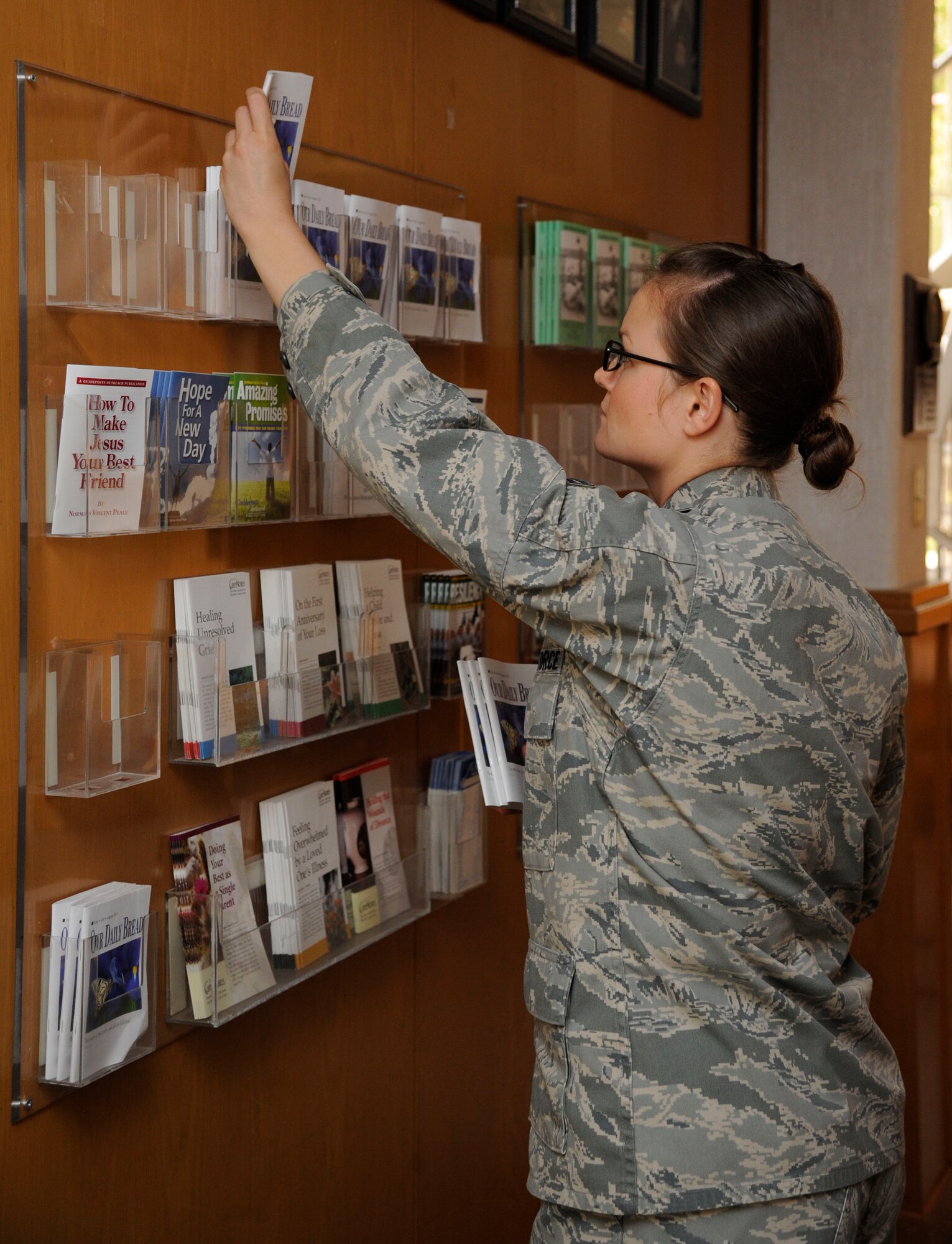 Senior Airman Alisha Smith, 2nd Bomb Wing Chaplain's Assistant, stocks religious literature at Chapel 2 on Barksdale Air Force Base, La., July 22, 2013. The literature is reference material for Airmen who may be in distress and is designed to help Airmen get through life's challenges. (U.S. Air Force photo/Airman 1st Class Andrew Moua)