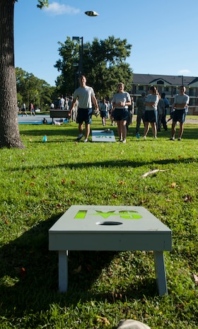 Airman 1st Class Zachary Huffman, 628th Logistics Readiness Squadron Petroleum Oil and Lubricants fuels distribution, tosses a bean bag during a corn hole game July 19, 2013, at the Dorm Challenge at Joint Base Charleston - Air Base, S.C. The quarterly competition is a Wing initiative intended to encourage resident interaction and camaraderie as part of Comprehensive Airman Fitness.  The Dorm Challenge consisted of push-ups, sit-ups, and games of cornhole and basketball. (U.S. Air Force photo/Senior Airman Ashlee Galloway)