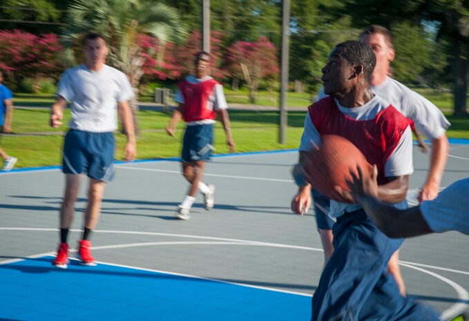 Senior Airman Maurice Hargraves, 437th Aircraft Maintenance Squadron crew chief, drives for a lay-up during a basketball game July 19, 2013, at the Dorm Challenge at Joint Base Charleston - Air Base, S.C. The quarterly competition is a Wing initiative intended to encourage resident interaction and camaraderie as part of Comprehensive Airman Fitness.  The Dorm Challenge consisted of push-ups, sit-ups, and games of cornhole and basketball. (U.S. Air Force photo/Senior Airman Ashlee Galloway)