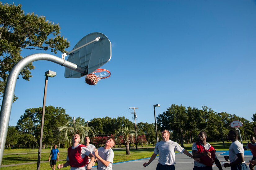 Senior Airman Maurice Hargraves, 437th Aircraft Maintenance Squadron crew chief, makes a basket during a basketball game July 19, 2013, at the Dorm Challenge at Joint Base Charleston - Air Base, S.C. The quarterly competition is a Wing initiative intended to encourage resident interaction and camaraderie as part of Comprehensive Airman Fitness.  The Dorm Challenge consisted of push-ups, sit-ups, and games of cornhole and basketball. (U.S. Air Force photo/Senior Airman Ashlee Galloway)