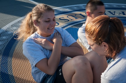 Airman 1st Class Katherine Stanton, 15th Airlift Squadron loadmaster, performs sit-ups July 19, 2013, at the Dorm Challenge at Joint Base Charleston - Air Base, S.C. The quarterly competition is a Wing initiative intended to encourage resident interaction and camaraderie as part of Comprehensive Airman Fitness.  The Dorm Challenge consisted of push-ups, sit-ups, and games of corn hole and basketball. (U.S. Air Force photo/Senior Airman Ashlee Galloway)