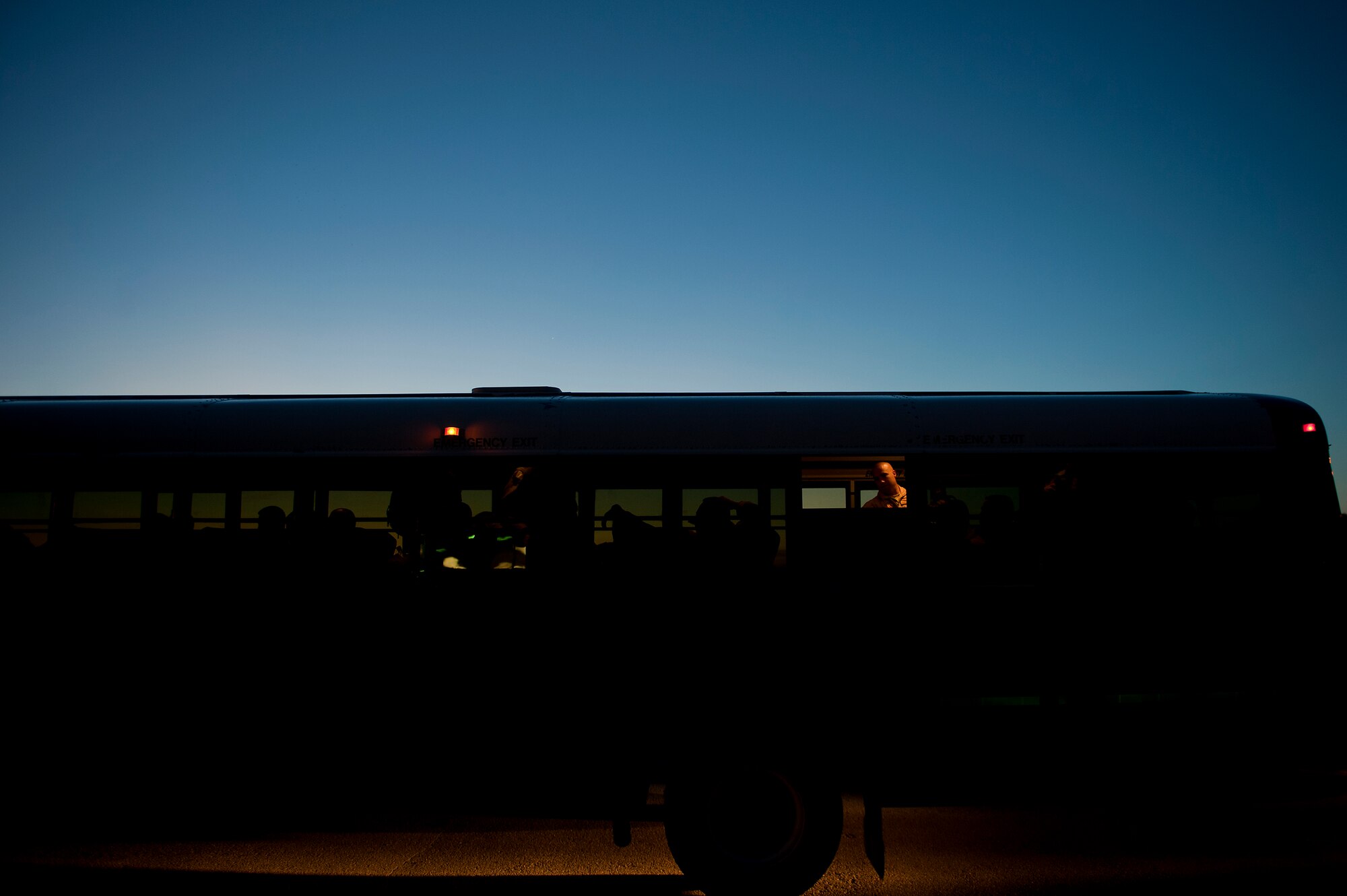 Airmen from the 9th Bomb Squadron (BS) take their seats on-board a bus heading to the passenger terminal prior to deploying to Southwest Asia July 19, 2013, at Dyess Air Force Base, Texas. More than 300 servicemembers from the 9th BS, 7th Aircraft Maintenance Squadron, 7th Munitions Squadron and 7th Operations Support Squadron deployed in support of U.S. Air Force Central Command. (U.S. Air Force photo by Airman 1st Class Damon Kasberg/Released)