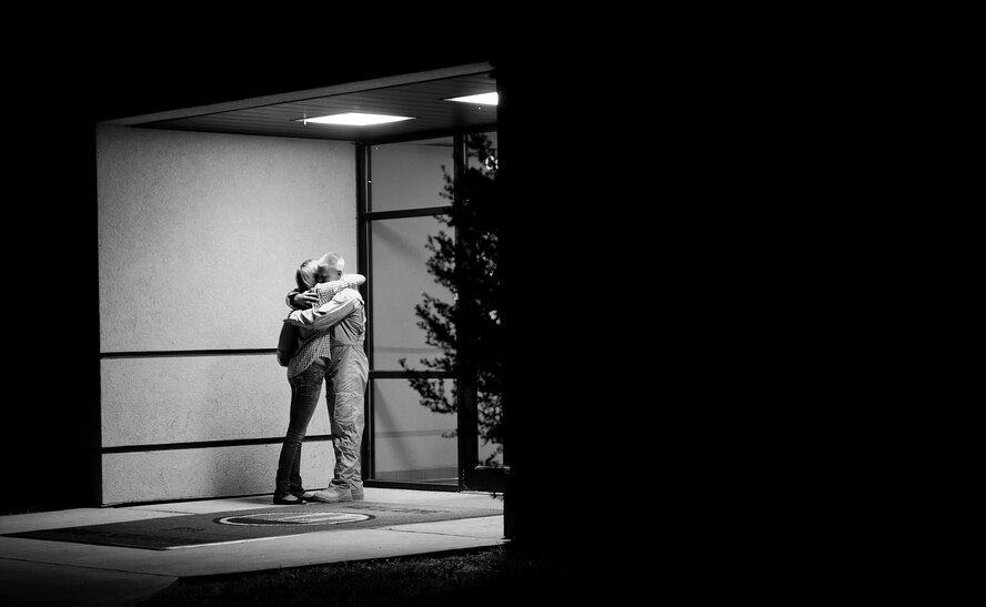 An Airman from the 9th Bomb Squadron (BS) hugs a loved one prior to deploying to Southwest Asia July 19, 2013, at Dyess Air Force Base, Texas. More than 300 servicemembers from the 9th BS, 7th Aircraft Maintenance Squadron, 7th Munitions Squadron and 7th Operations Support Squadron deployed in support of U.S. Air Force Central Command. (U.S. Air Force photo by Airman 1st Class Damon Kasberg/Released)