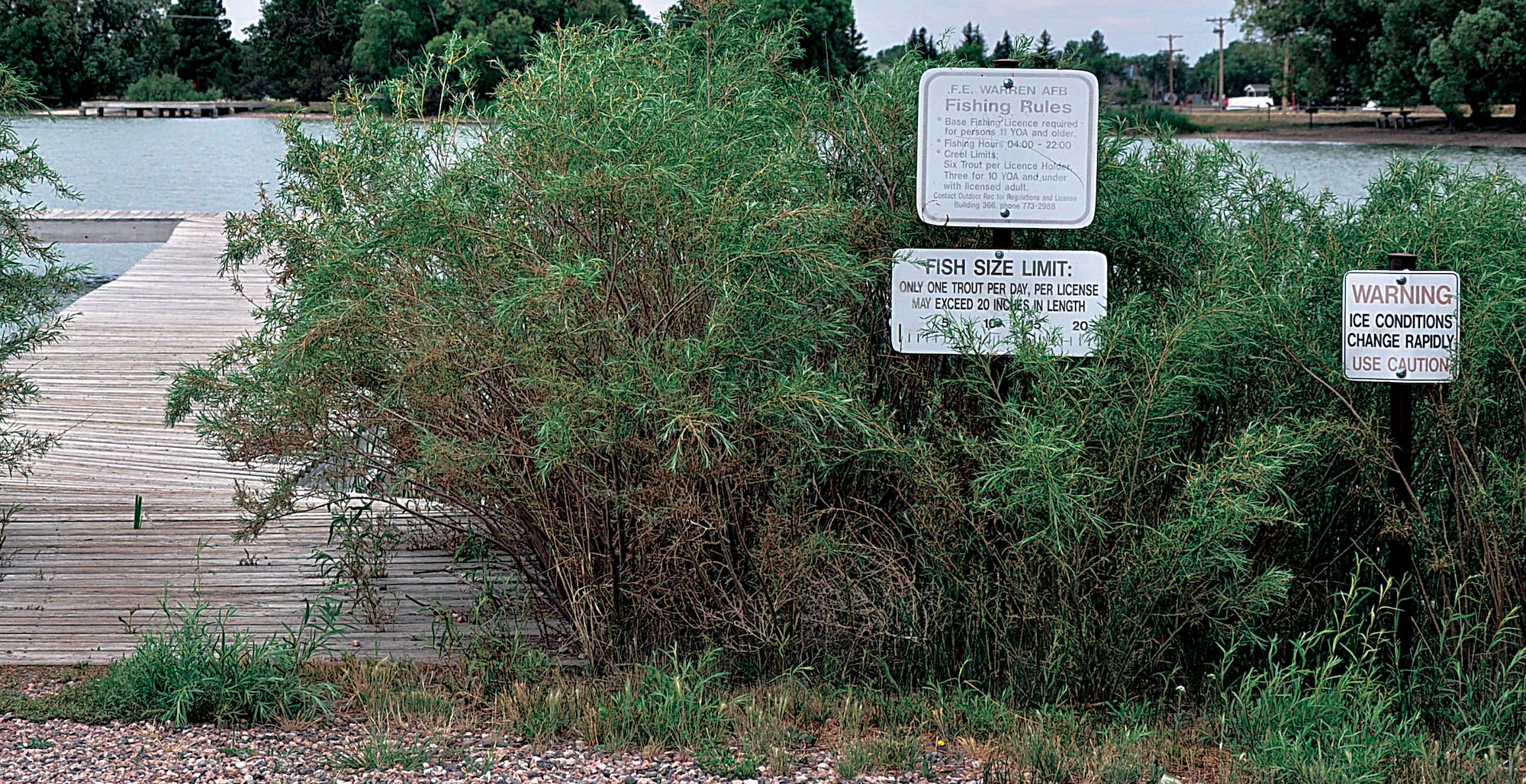 Warning and fishing regulation signs surround the piers of the South Pearson Lake here. The North Pearson Lake is currently undergoing cosmetic improvements including being deepened to 12-feet and is scheduled to be refilled and restocked before fall. (U.S. Air Force photo by Senior Airman Mike Tryon)