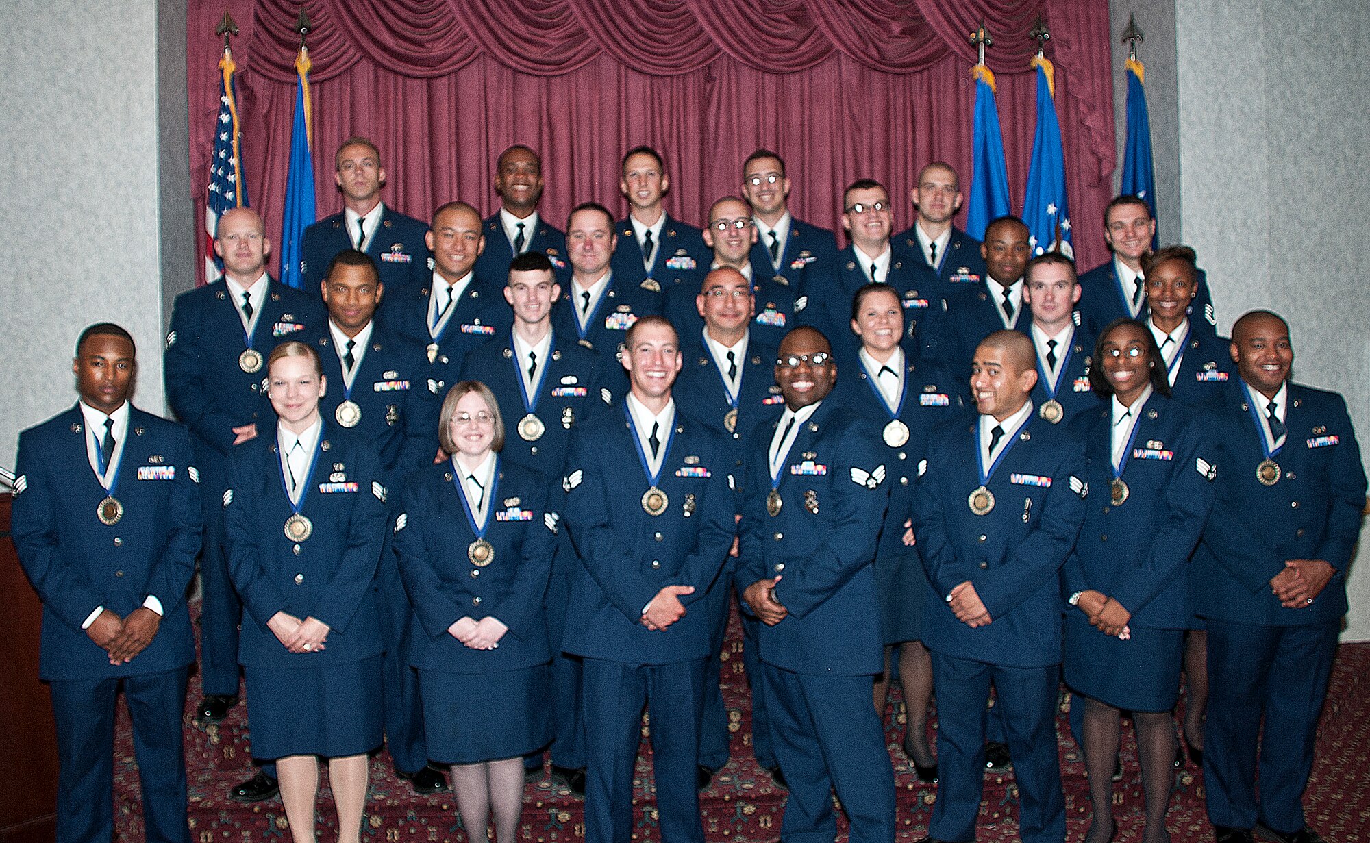 Airman Leadership School Class 13-E poses for a group photo on the stage in the Trail’s End Club, F.E. Warren Air Force Base, Wyo., at the beginning of their graduation ceremony July 10, 2013. ALS graduates have undergone professional military training in leadership, and the training is required for an Airman to become supervisors. (U.S. Air Force photo by Airman 1st Class Jason Wiese)