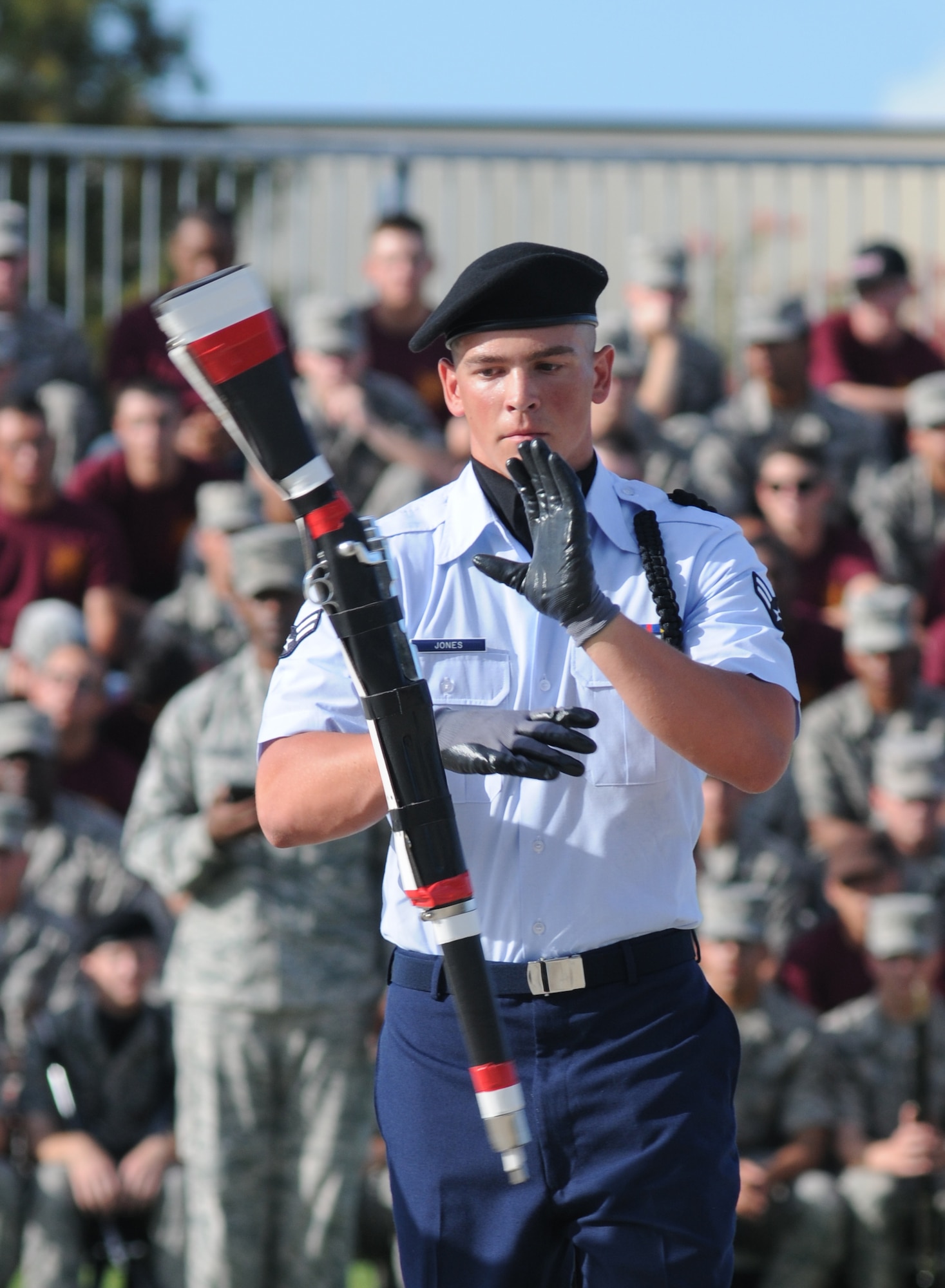 Airman 1st Class Cody  Jones, 335th Training Squadron, spins a rifle during the freestyle portion of the 81st Training Group drill down competition July 19, 2013, behind the Levitow Training Support Facility, Keesler Air Force Base, Miss.  The 335th TRS swept the competition, winning first place in every category to include open ranks, regulation, freestyle and overall.  (U.S. Air Force photo by Kemberly Groue)