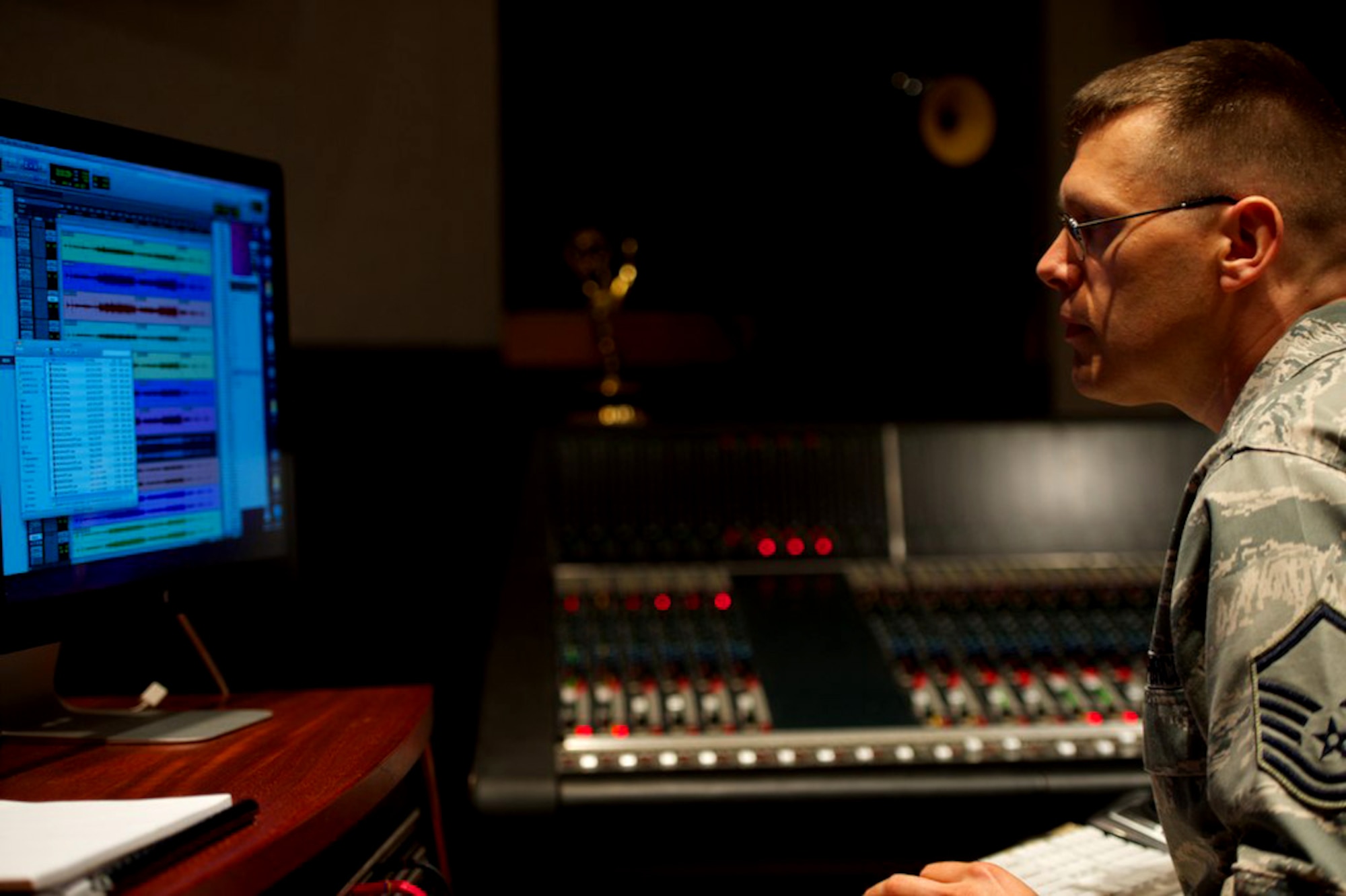 Master Sgt. James DeVaughn makes adjustments to an audio track July 3, 2013, in a recording studio at Bolling Air Force Base, Washington, D.C. DeVaughn, an audio engineer and production assistant with The U.S. Air Force Band, recently received a regional Emmy® Award in recognition of his contribution to the audio recording of a live Veteran's Day concert, Nov. 11, 2012. (U.S. Air Force photo/Alexander W. Riedel)